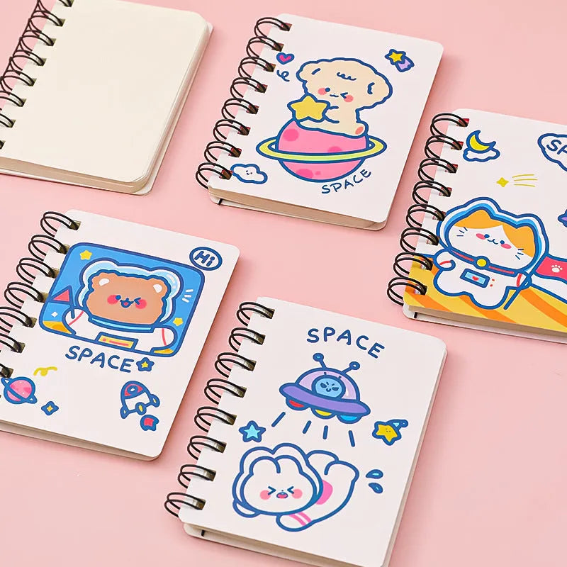 Astronaut-themed pocket flipper notebook showing compact 10.5 by 8 cm dimensions with space character cover options