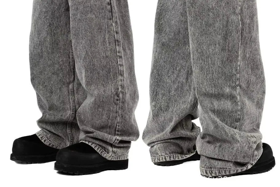 Grey loose straight-leg denim trousers showing mid-waist design and relaxed fit