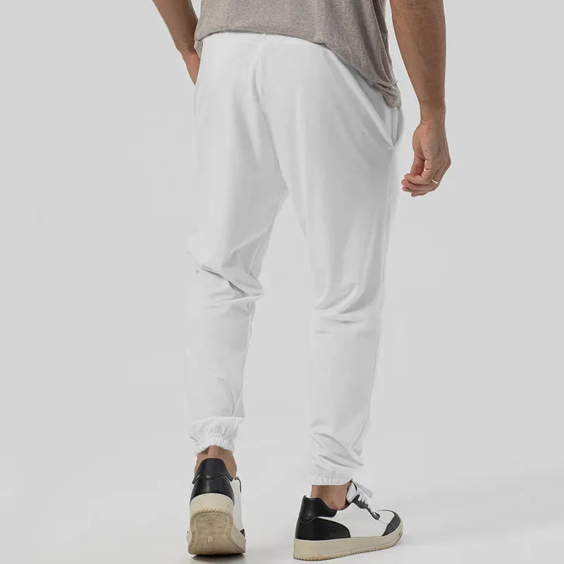 Men's grey straight-leg cotton blend sweatpants with an elasticated waistband on a white background.