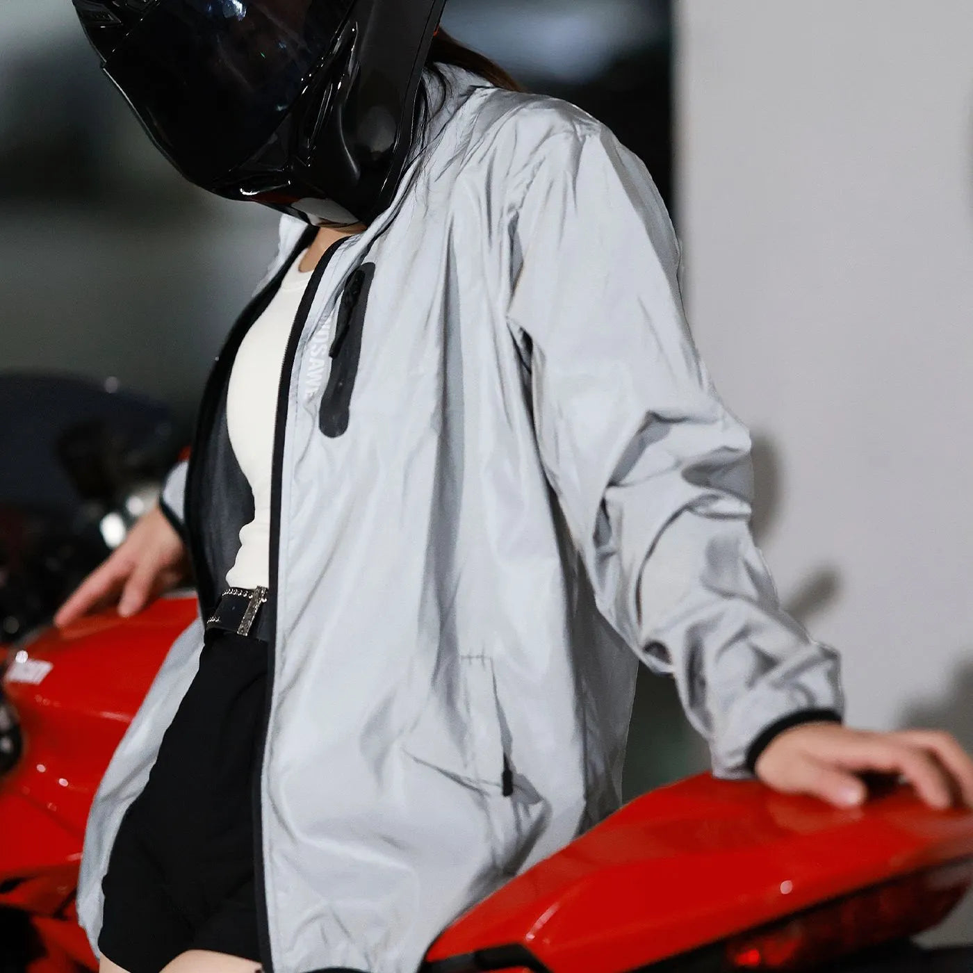 Silver waterproof polyester long sleeve top shown on a hanger.