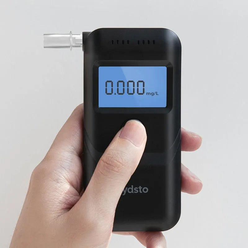 Black handheld household alcohol tester for breath checks and drunk driving detection