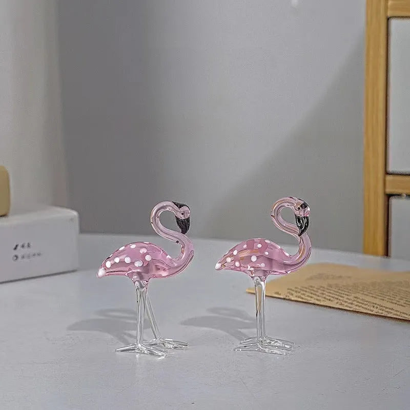 Pink crystal flamingo decorative ornament on a table, modern minimalist style.