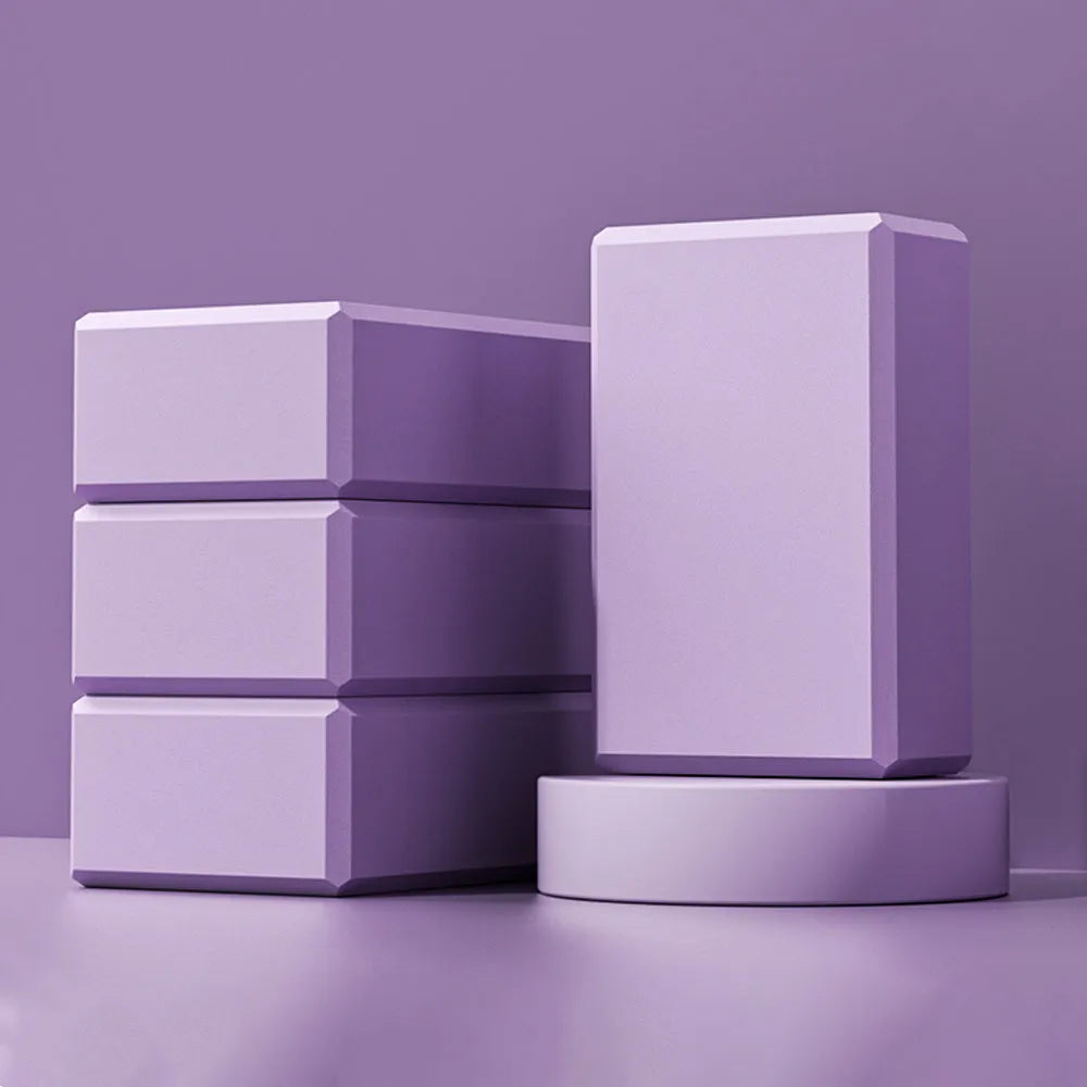 Blue high-density EVA foam yoga block showing ridged sides and hexagonal facets.