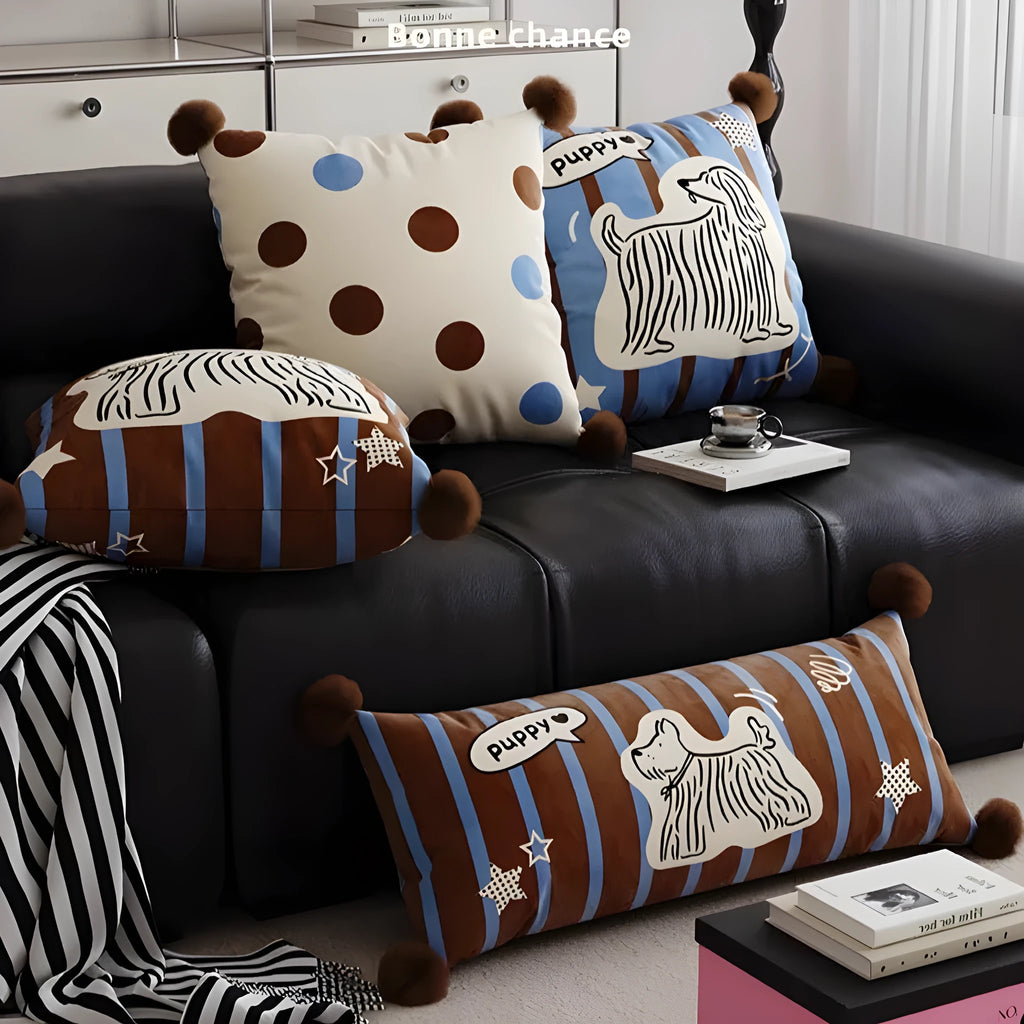 Blue cartoon animal print decorative pillow on a grey sofa.