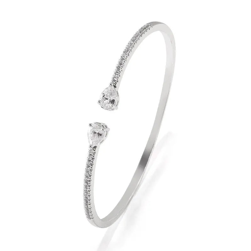 Copper fashion bracelet with multi-zircon inlay decoration, shown in white and blue colour options.