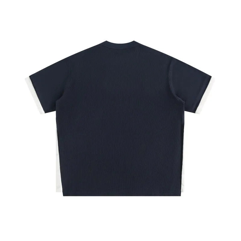 Loose-fitting short-sleeved waffle t-shirt with retro alphabet embroidery in yellow.