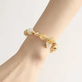 Gold coloured rutilated quartz bracelet with Korean style design on wrist