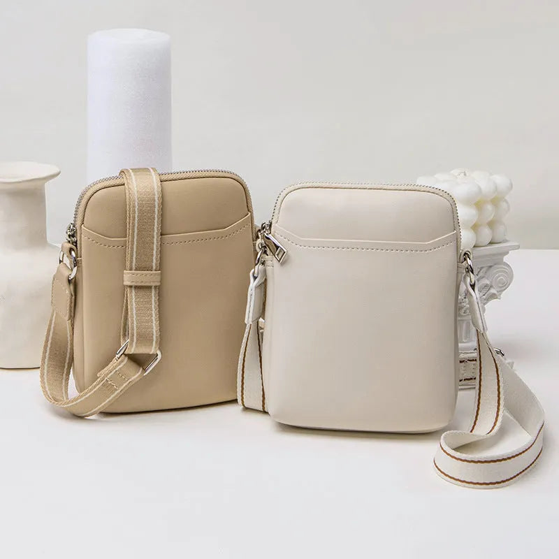 Women's solid colour PU crossbody shoulder bag showing compact dimensions and adjustable strap
