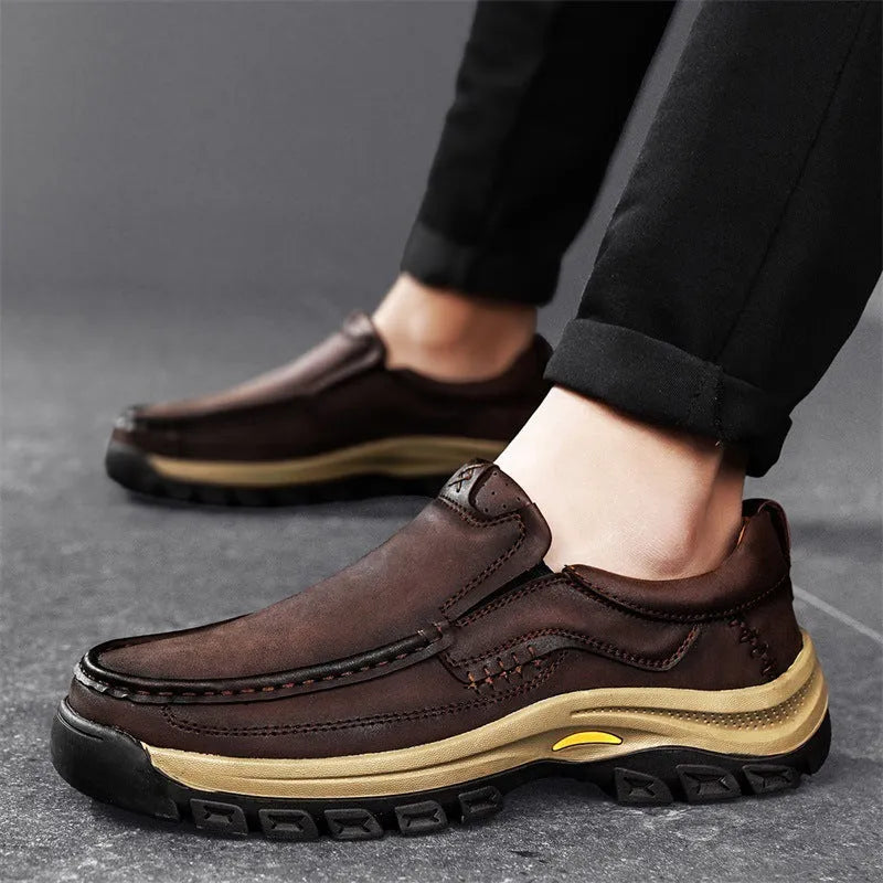 Men's black leather mountaineering shoes with thick rubber soles and round toe.