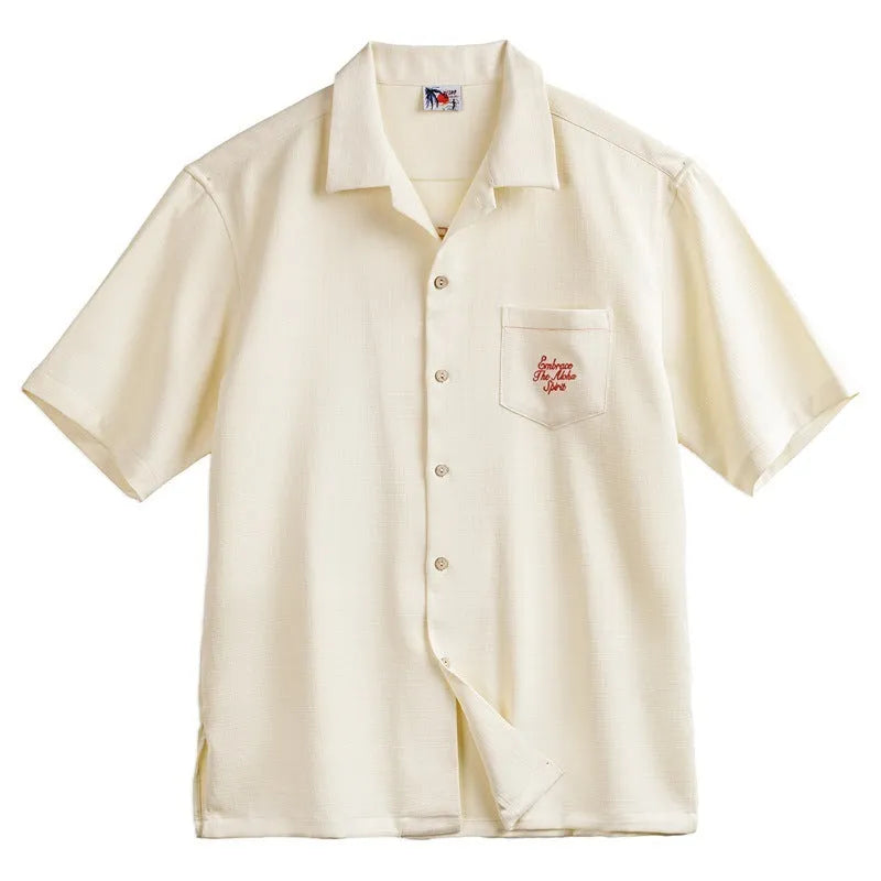 Light apricot coloured men's shirt with a bamboo and floral pattern and a Cuban collar.
