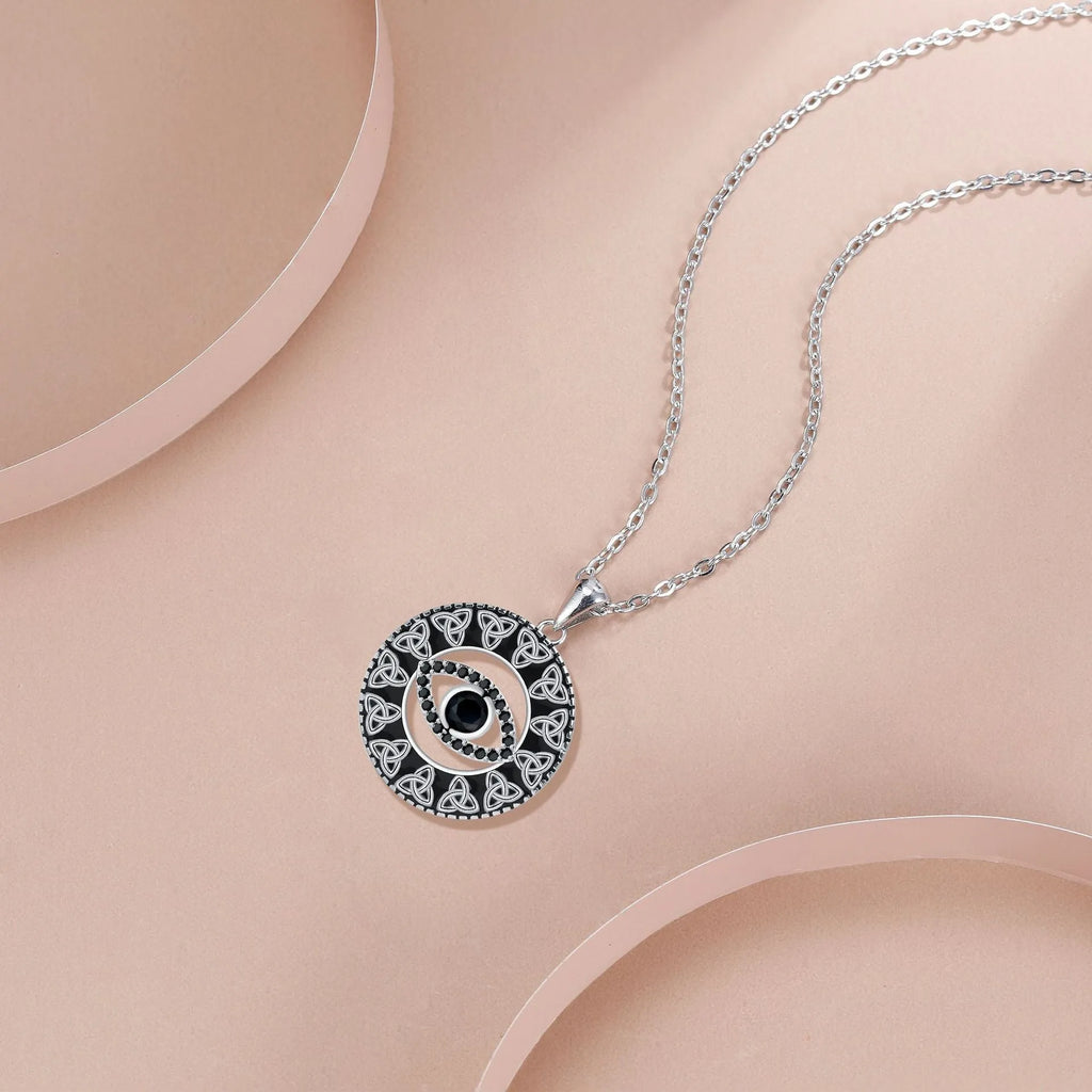 Blue Devil's Eye pendant on a copper cross chain necklace for women.