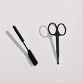 Black ambidextrous pet grooming brush with soft bristles and a separate comb attachment for dogs and cats.