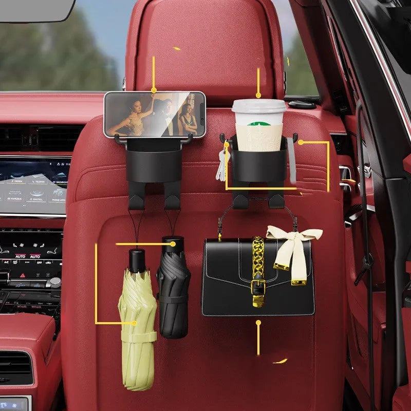 Black plastic car hook seat back organiser with cup holder mounted on vehicle headrest