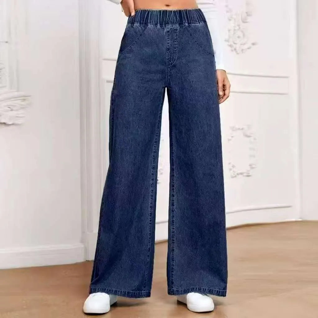 Plus size light blue washed wide-leg straight-leg jeans on a hanger.
