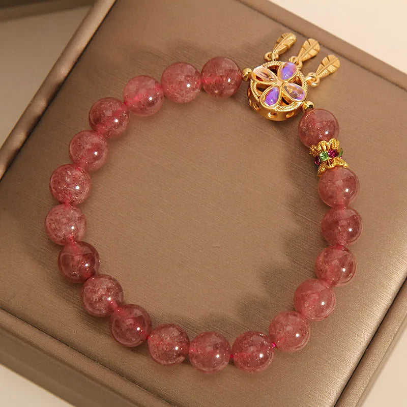 Natural strawberry quartz bracelet for women with a four-leaf dream catcher pendant on an adjustable chain.