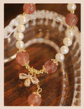 Strawberry quartz colour crystal bracelet with bow and stringed pearls.