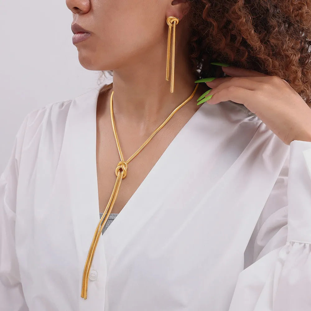 Gold knotted tassel pendant on titanium steel snake chain necklace with matching electroplated earrings