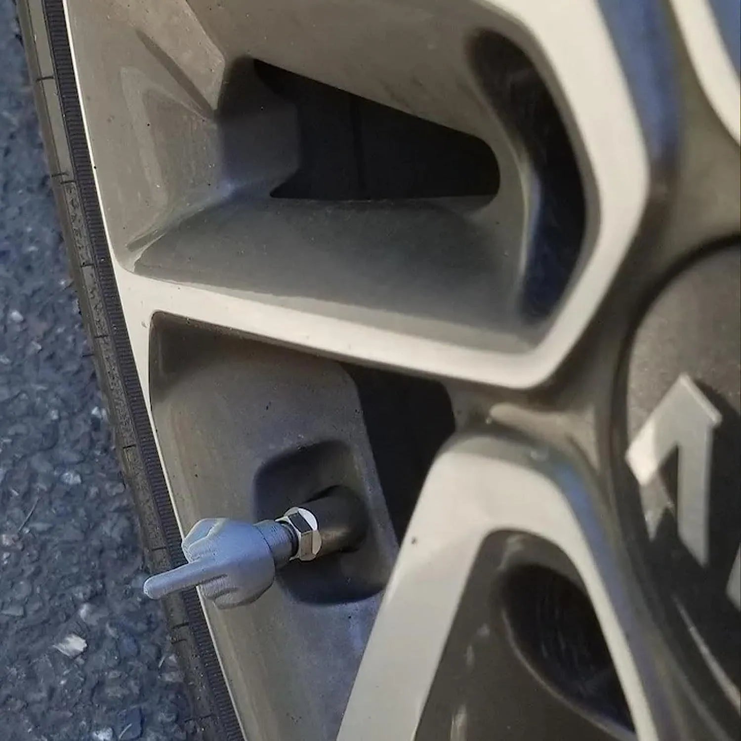 Eight latex car tyre valve caps, four black and four skin colour, for dust protection.