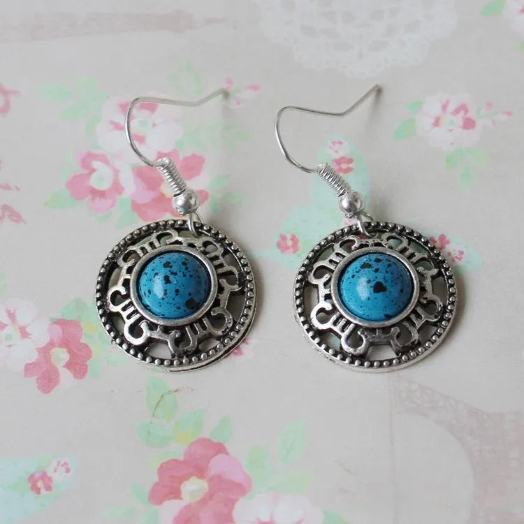 Handmade Miao ethnic silver earrings with turquoise geometric flower disc design