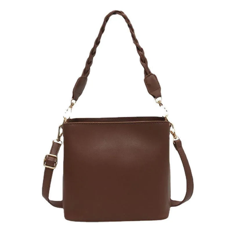 Retro unisex brown PU bucket bag with woven detail, shown with crossbody strap.