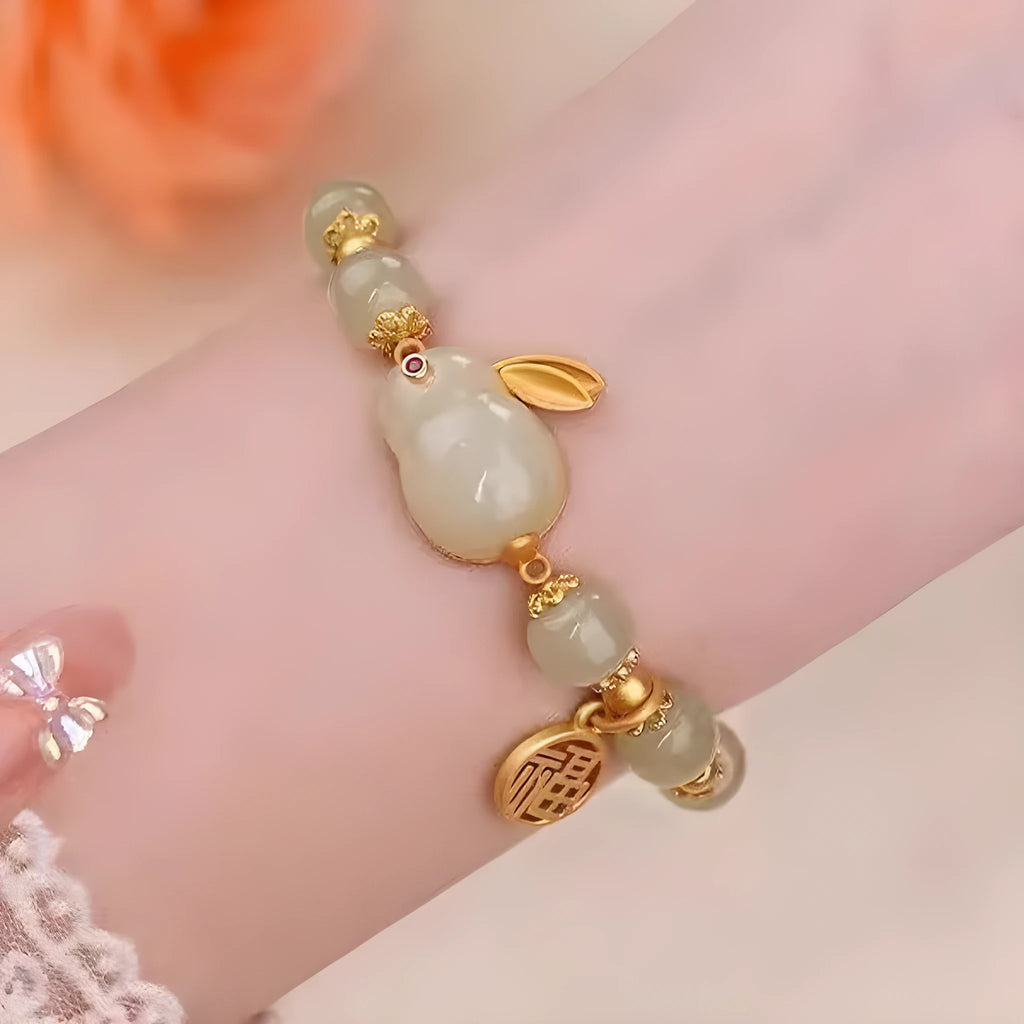 Women's green fu jade hare bracelet with black cord and lily motifs