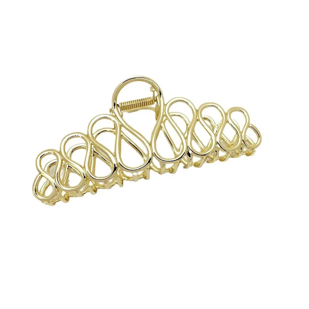 Minimalist large hair clip with electroplated alloy construction and tassel accents in gold or silver colour