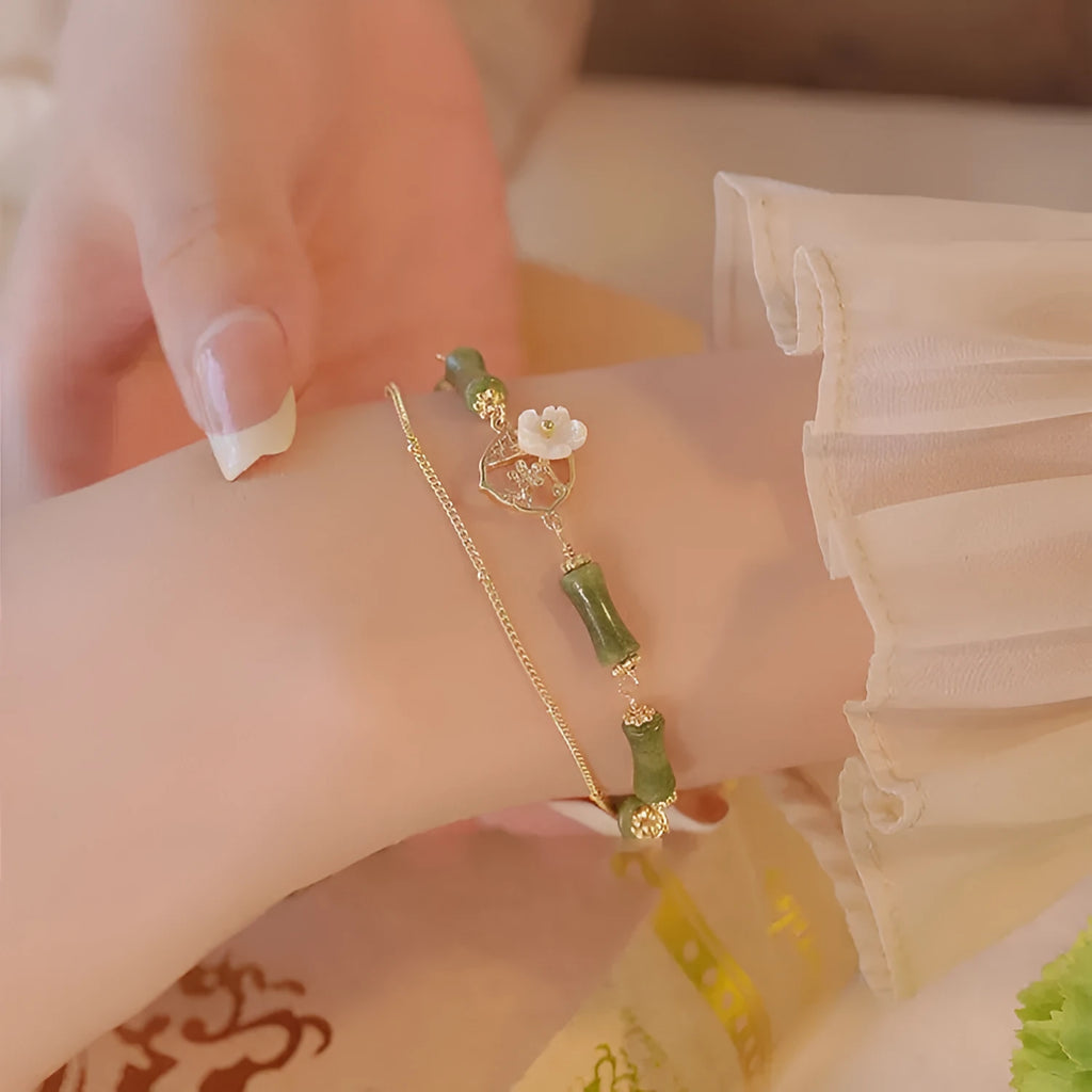 Natural olivine women's bracelet with a double layer twin bells of ireland charm and olive branch detail.