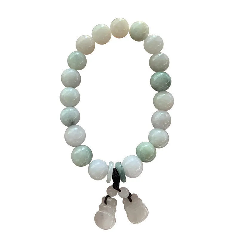Natural green jade hanging bracelet with Maitreya Buddha pendant on a wrist.