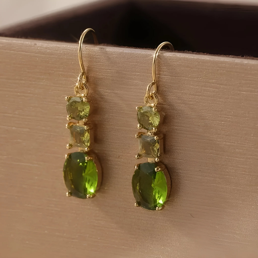 A pair of green geometric quadrilateral earrings made from copper, showing a simple retro bohemian style.
