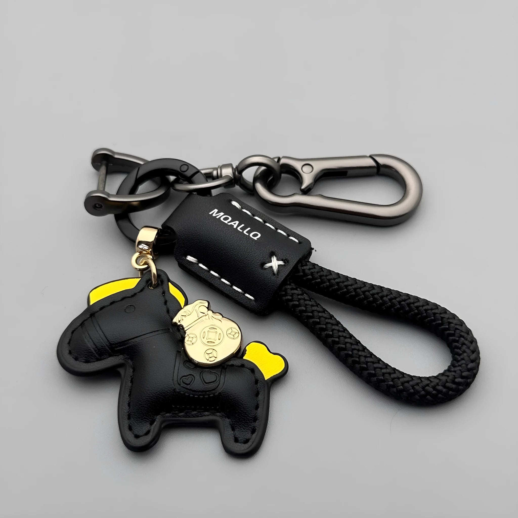 Handmade cowhide car keychain pendant with a zinc alloy pony buckle and coloured flanelle rope strap.
