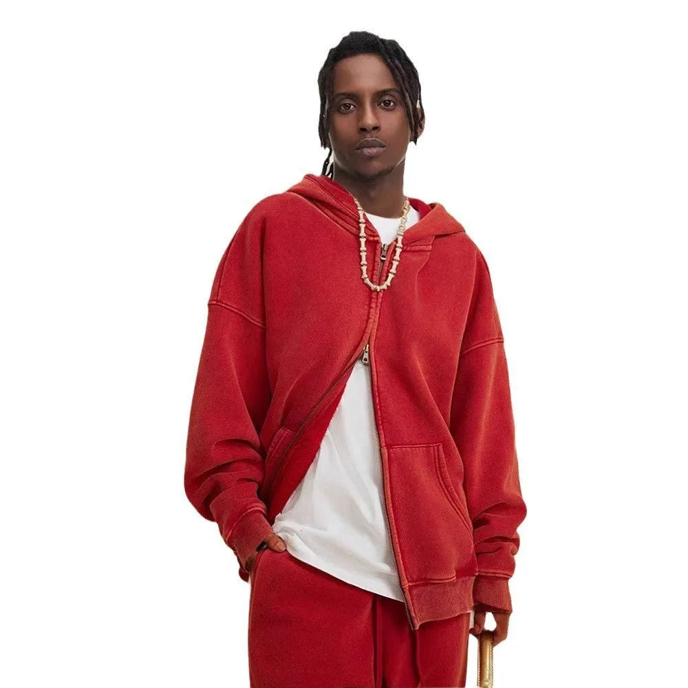 Man wearing a washed black fleece-lined hooded cardigan with a double zipper