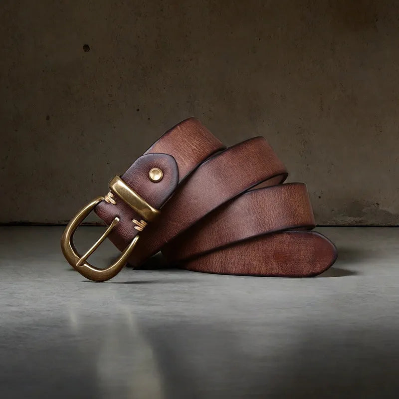 Men's black cattlehide leather belt with copper pin buckle on a pair of jeans