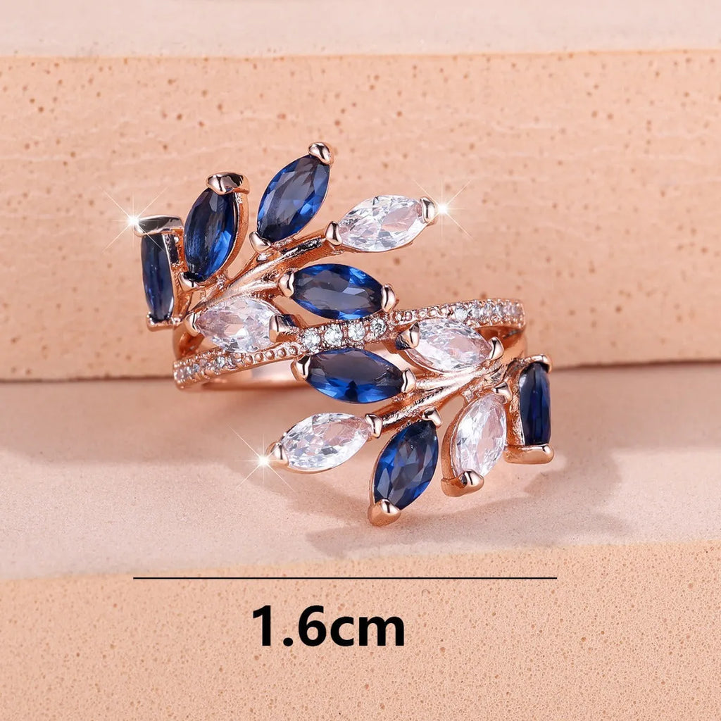Adjustable copper leaf ring in platinum or rose gold finish on a white background