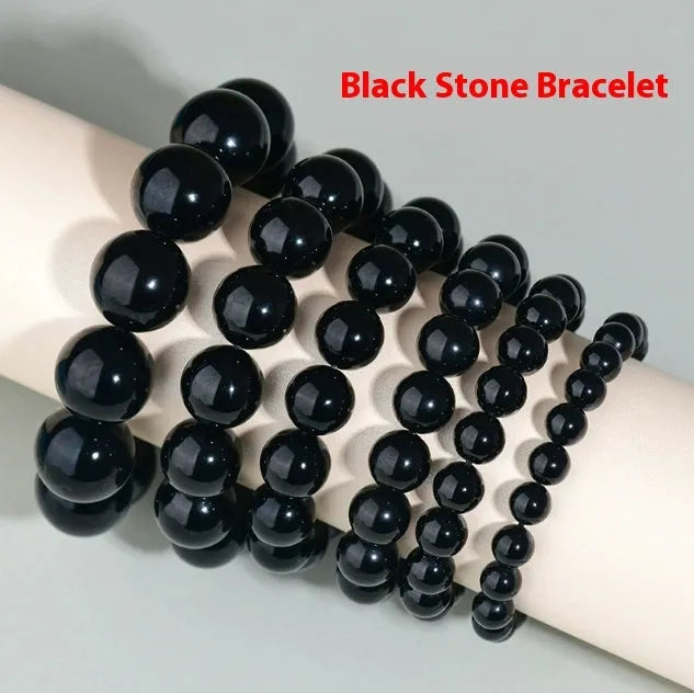Hand-woven black obsidian bracelet with round beads, shown as a couple's set on a wrist.