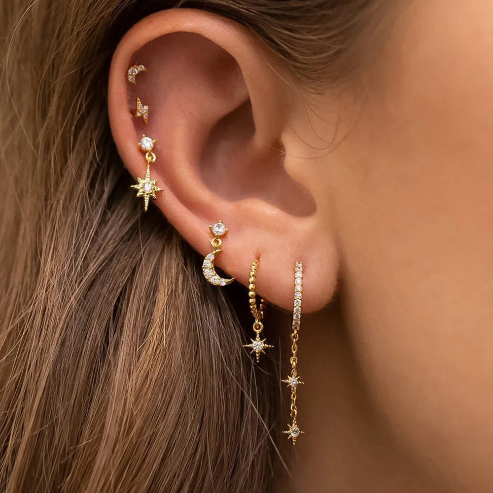 Six pairs of gold electroplated earrings including chain tassel designs and zircon studs for women