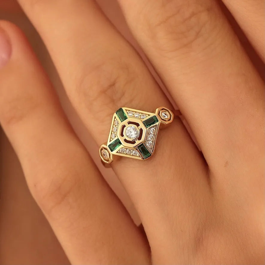 Square geometric women's ring with a lvzuan colour gemstone centrepiece on a plain background.