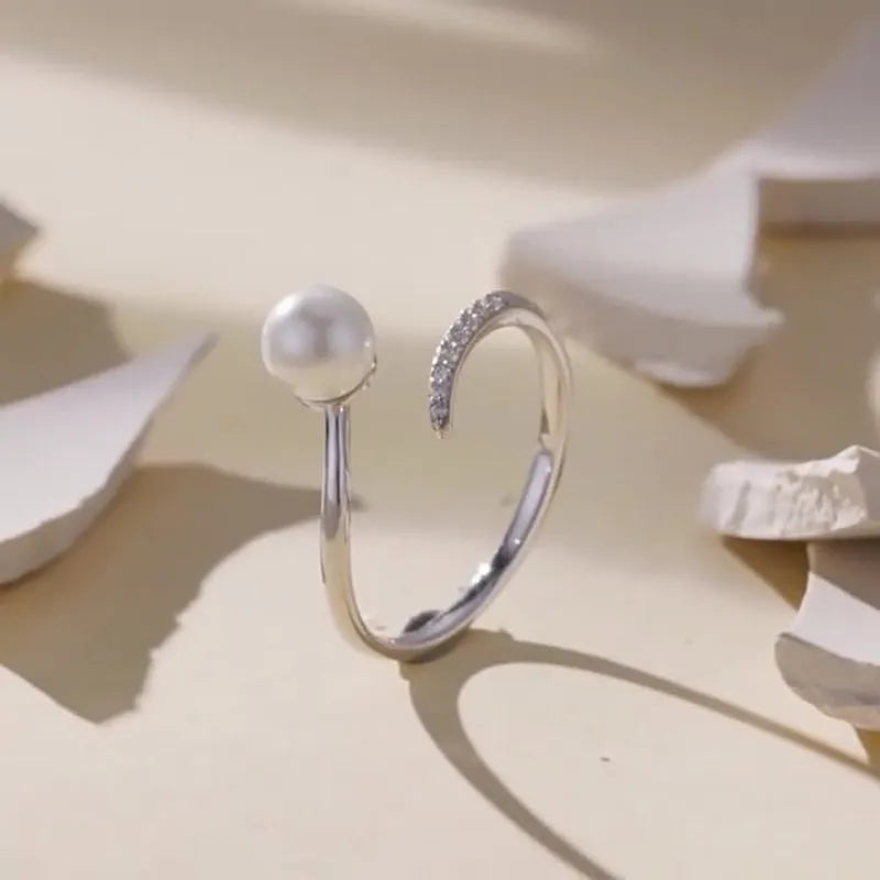 Adjustable S925 sterling silver ring with shell pearls in open loop design
