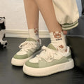 Green women's casual flat shoes with a PU mesh upper and round toe on a plain background.