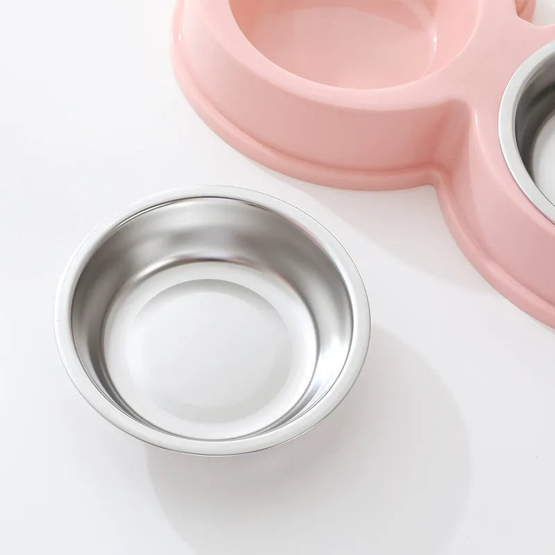 Blue stainless steel double pet bowl with frog design, showing separate food and water compartments on a non-slip base.
