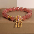 Natural strawberry quartz bracelet for women with a four-leaf dream catcher pendant on an adjustable chain.