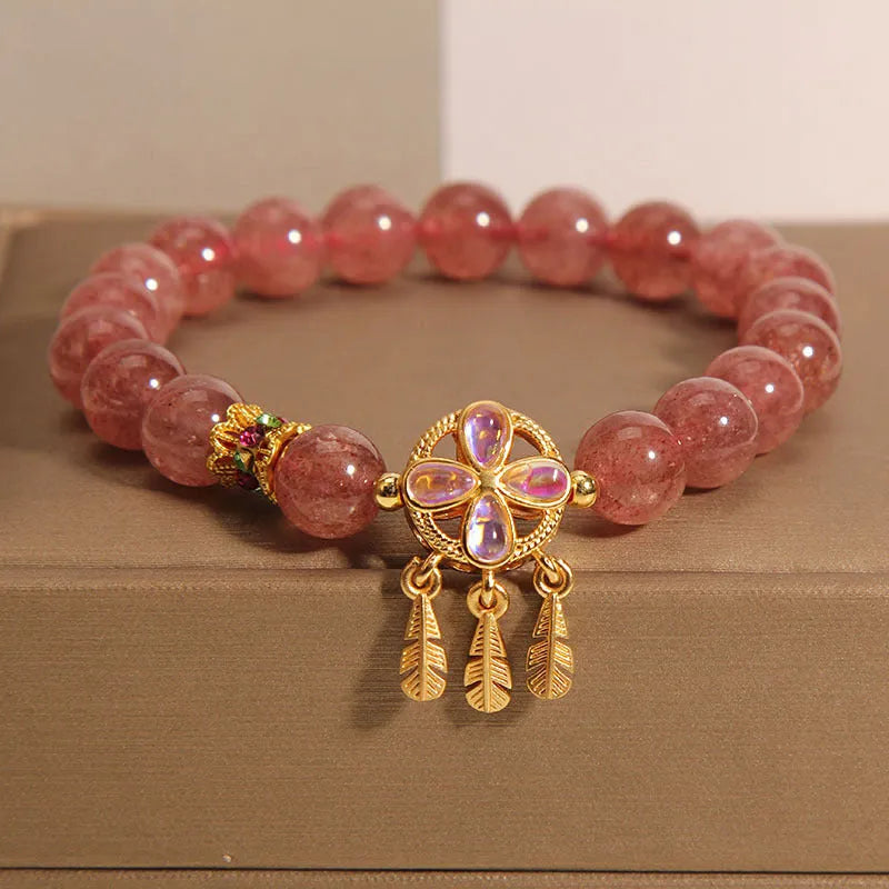 Natural strawberry quartz bracelet for women with a four-leaf dream catcher pendant on an adjustable chain.