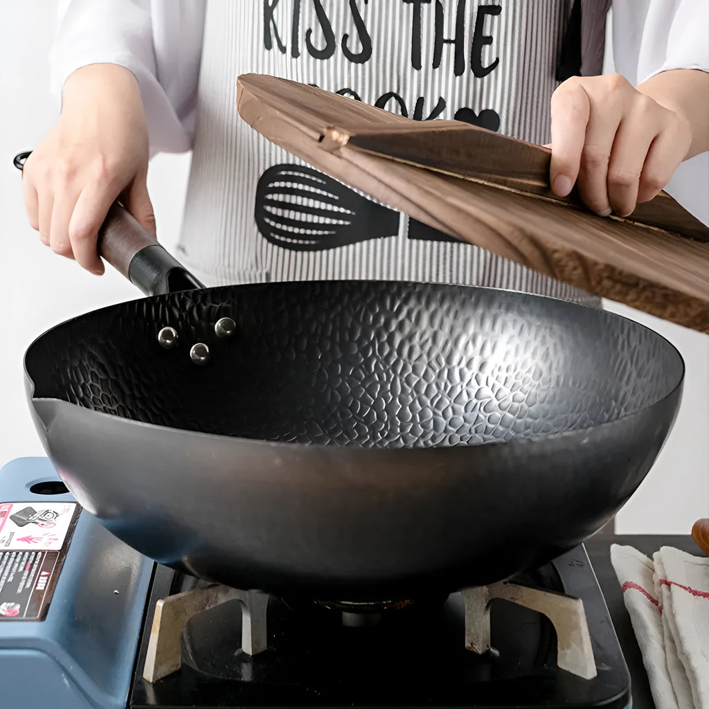 Traditional black iron wok pan with wooden handle measuring 32cm diameter