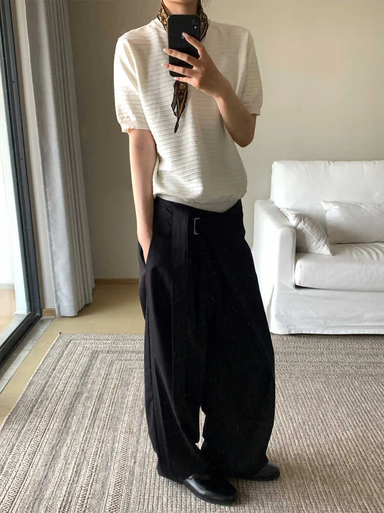 Black straight-leg women's trousers with a pleated front and adjustable waistband on a neutral background.