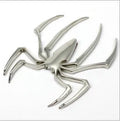 Three-dimensional metal spider bumper sticker in zinc alloy on a car bumper.