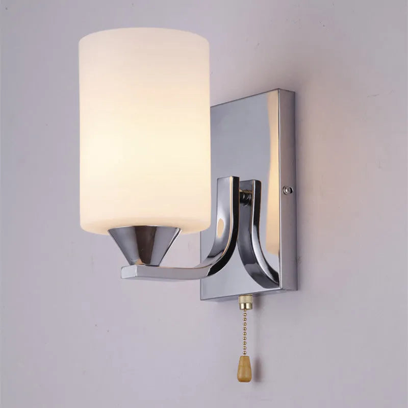 Minimalist chrome wall lamp with a glass shade shown in single head and double head configurations