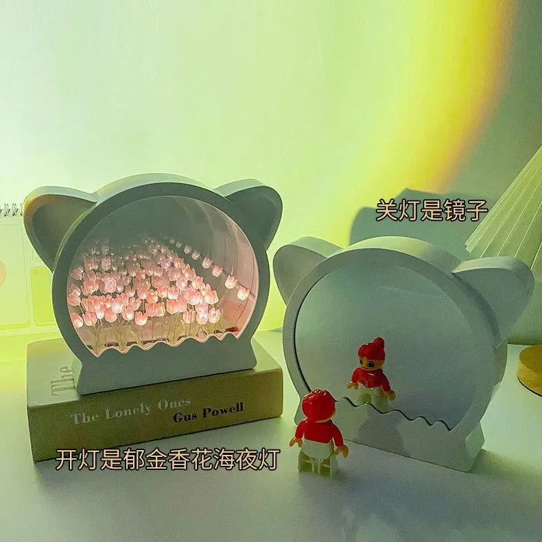 DIY handmade cat head shaped night lamp decorated with pink tulip flowers on a blue sea-themed background