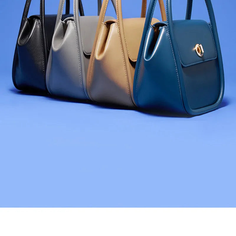 Wing-shaped women's leather handbag with latch closure and cross-body strap in available colours.