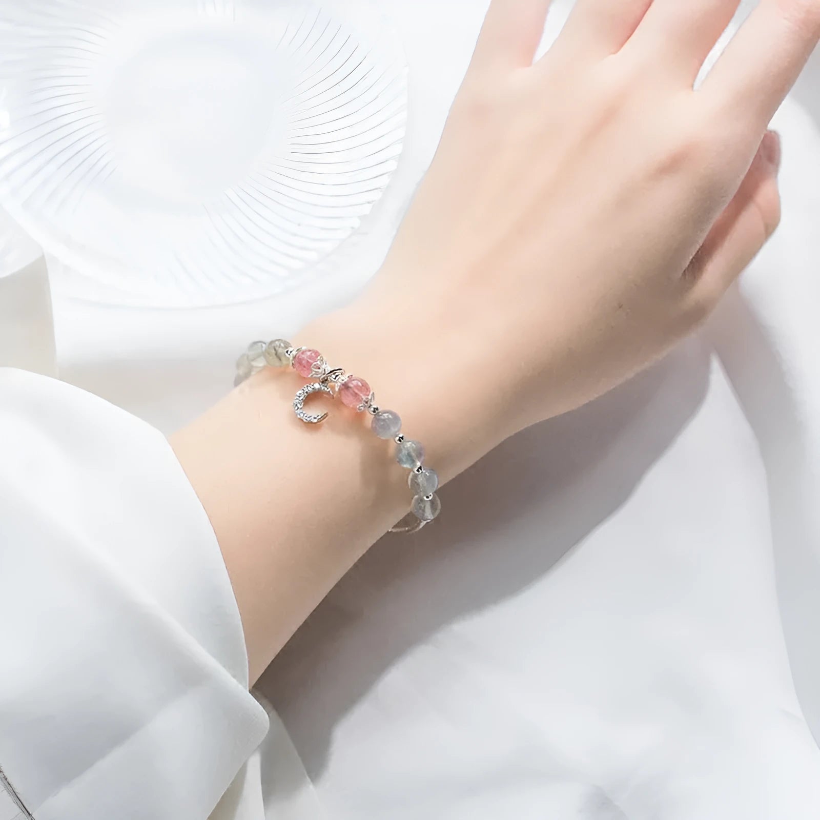 Handmade silver-tone adjustable bracelet with a moonstone bead and crescent moon charm.
