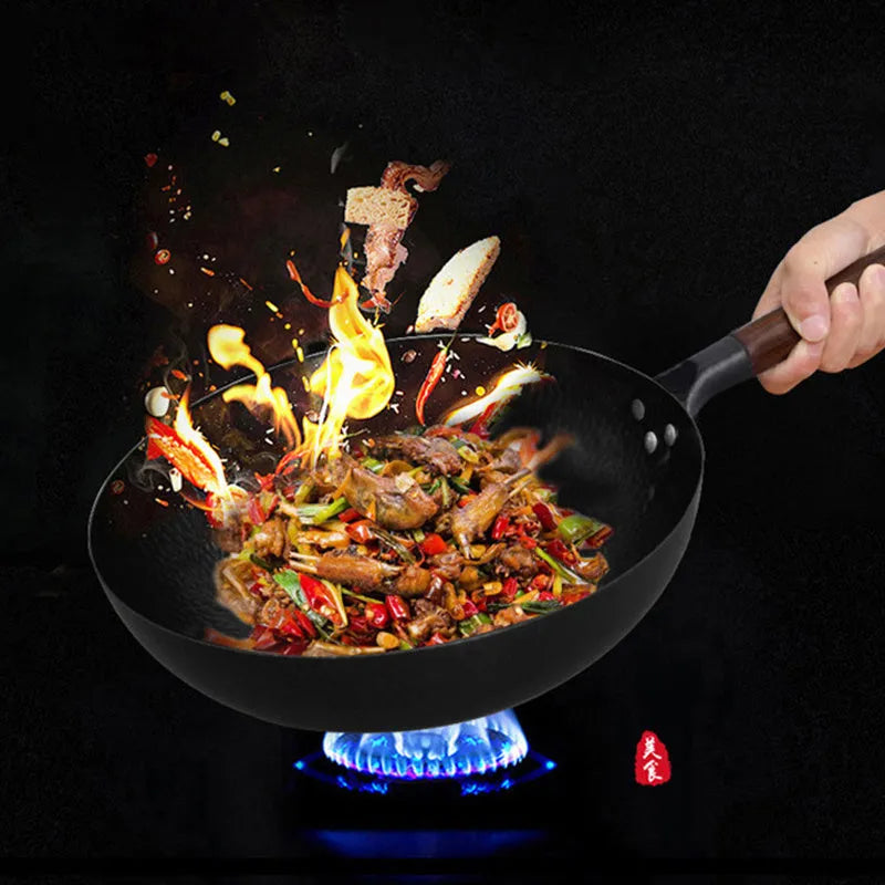 Traditional black iron wok pan with wooden handle measuring 32cm diameter