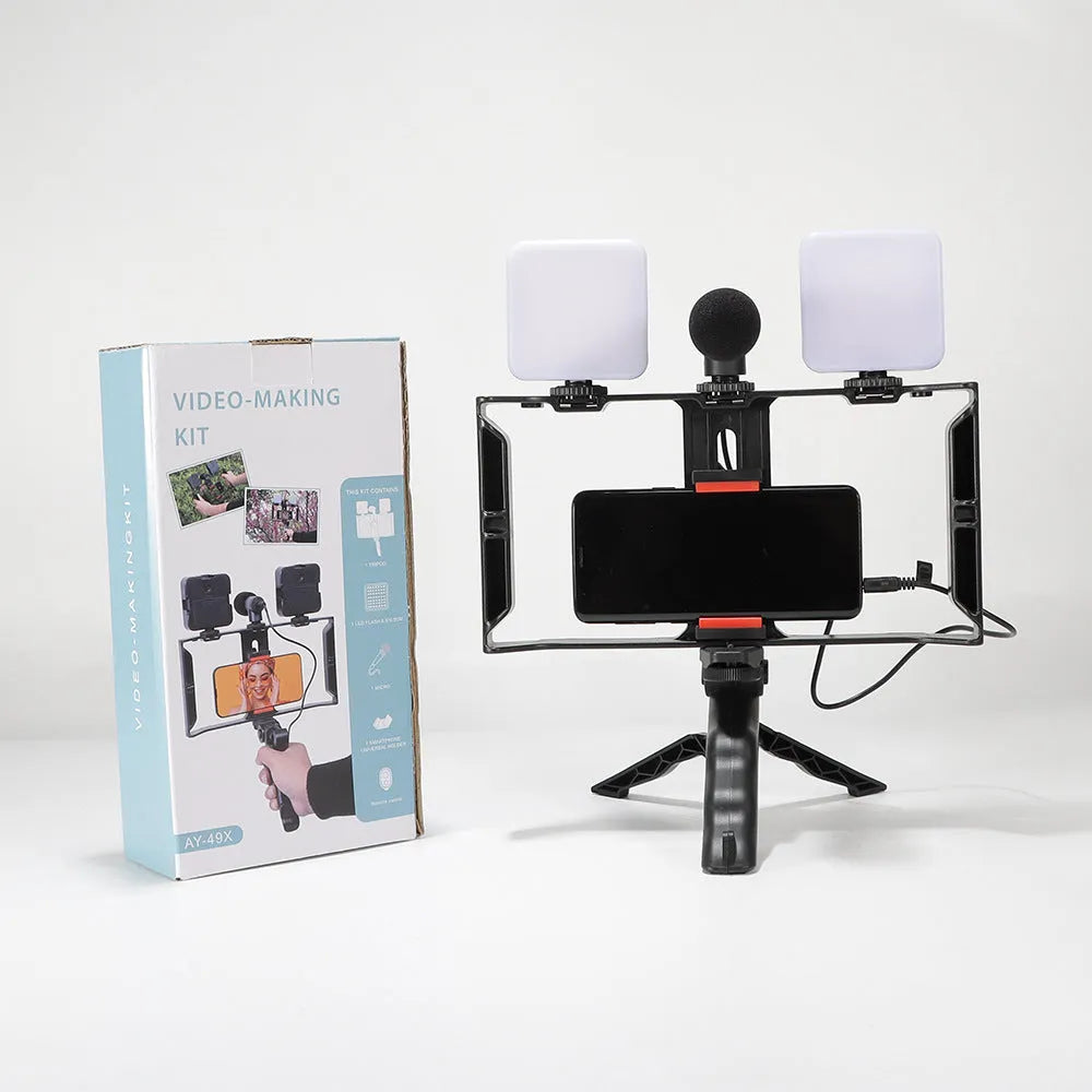 Compact black LED mini square camera flash with hot shoe mount on a small tripod stand.